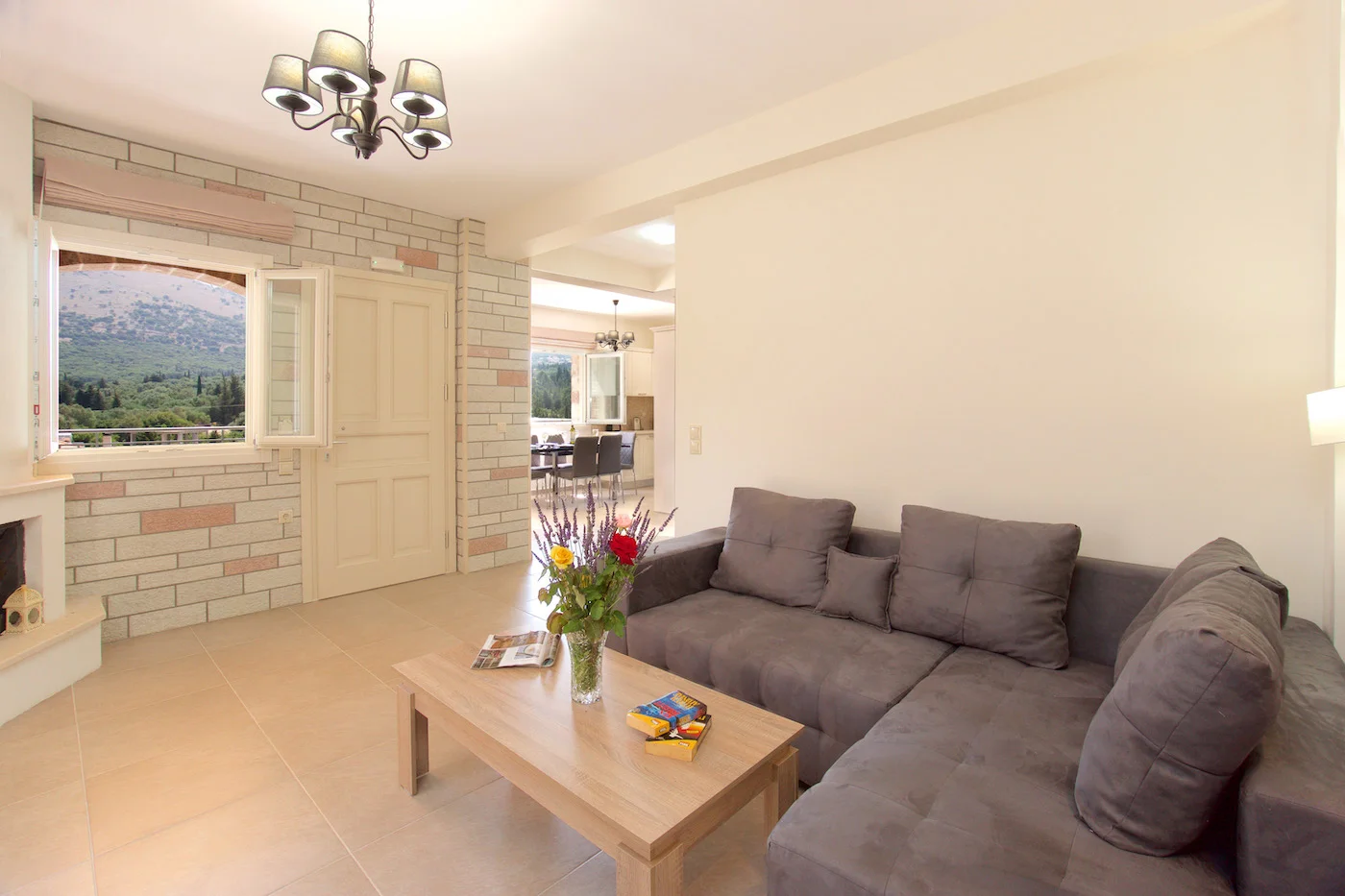 Cozy living area with corner sofa and stone walls, Villa Miranda Agia Efimia